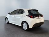 the back end of a white toyota yaris parked in a room