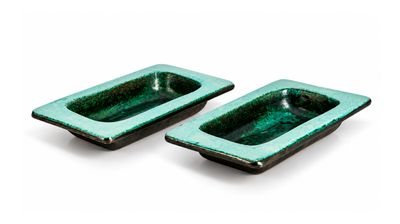 pair of green ceramic ashtrays on a white background