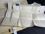 some old papers are sitting on top of a table next to a book