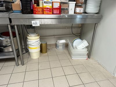 a metal table with a bunch of dishes on top of it