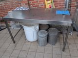 a table that has a bunch of buckets on top of it