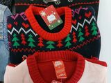 three sweaters that are on display in a store