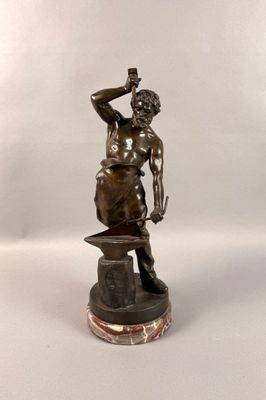 bronze statue of a man with a hammer on a marble base