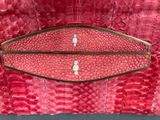 an image of a red purse with a gold handle