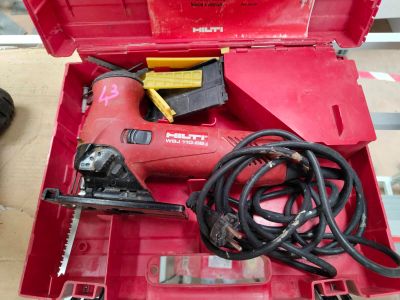 a red tool box with tools in it sitting on a table