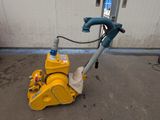 a yellow machine that is sitting on the ground