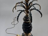 a black and gold lamp with a pineapple on it