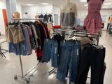 a lot of clothes hanging on a rack in a store