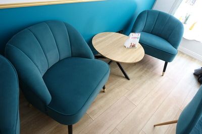 three chairs and a table in the corner of a room