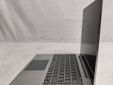 an open laptop computer sitting on top of a white surface
