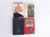 three books are stacked on top of each other on a white surface