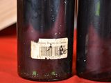 two bottles of wine that are sitting on a table