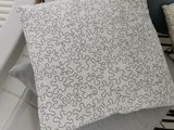 a close up of a chair with a pillow on it