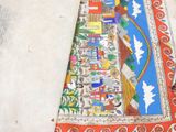 a colorful rug with a picture of a city on it