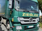 a green truck that is parked on the side of the road