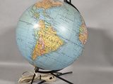 an image of a blue and yellow globe on a black stand