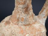 a very old vase that is sitting on a table