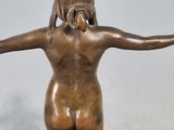 bronze statue of a little girl with her arms spread out