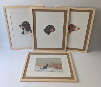 three framed prints of dogs on a white surface