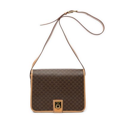 a brown and tan handbag with a brown handle