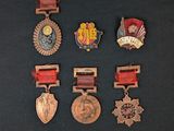 several medals are displayed on a black surface with a black background