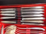 silverware in a red case on a table with a red cloth