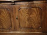 a wooden cabinet with two doors and a drawer underneath it