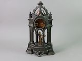 a bronze clock that is sitting on a table