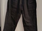 a pair of black pants hanging on a white wall