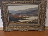 a picture of a painting on a shelf in a room