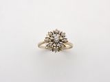 a gold and diamond ring with a cluster of diamonds