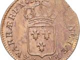a close up of a coin with a crown on top of it
