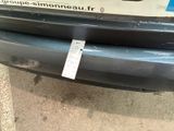a sticker on the bumper of a car that is parked on the side of the road