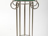 a metal table with a glass top on a white background