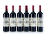 six bottles of red wine lined up in a row on a white surface