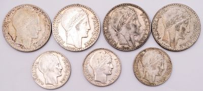 six different types of silver coins are shown on a white surface