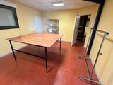 a table in the middle of a room with a window