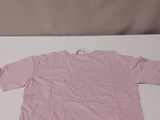 a pink shirt sitting on top of a white table