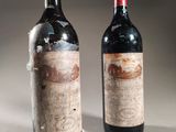 two bottles of wine sitting next to each other on top of a table