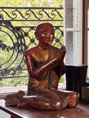 a statue of a person sitting on a table