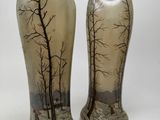 two vases that have been painted with trees on them