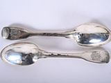 two spoons that are sitting next to each other
