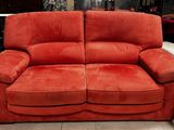 an image of a red couch and chair in a store