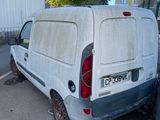 a white van parked in a parking lot next to a building