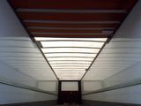 an image of a long hallway with a skylight in the ceiling