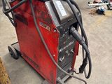 an image of a welding machine in a garage with other tools