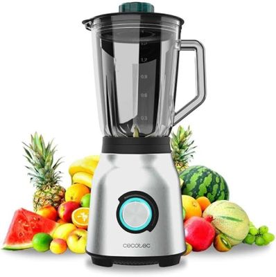 une photo d'un mixeur posé à côté d'un tas de fruits