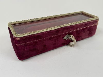 purple velvet jewelry box with gold trimming and a silver clasp
