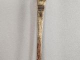 a close up of a spoon on a white surface