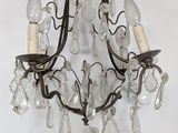 a chandelier hanging from the ceiling with several lights
